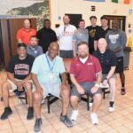 Coaches from Louisville, Detroit, and Northern Michigan pose for a photo. -Don Miller Photography