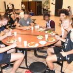 Athletes from Northern Michigan dine with Athletes from Detroit and Louisville. -Don Miller Photography