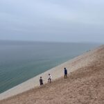 Contemplating the view and steep dune.